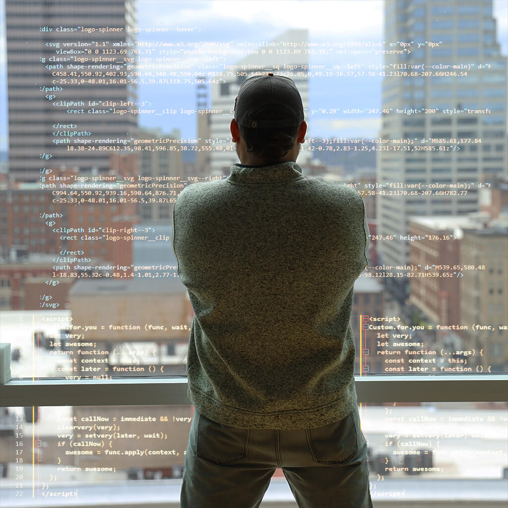 dev facing cityscape with code overlaid on window